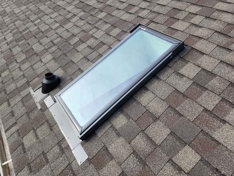 A brand new skylight on a freshly redone and resingled roof